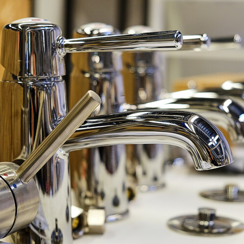 a row of commercial bathroom faucets