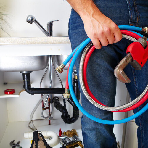 plumber standing beside a sink