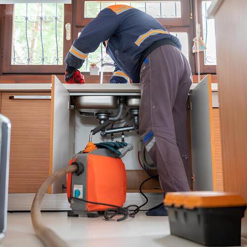 plumber providing drain cleaning